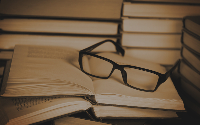 Glasses on open book. Concept of reading and education.